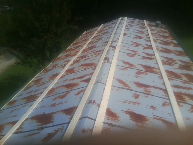 Rusted metal roof panels with new wood purlins before replacement — Storm Damage Roof Repair in Pasadena by Roofing Brothers